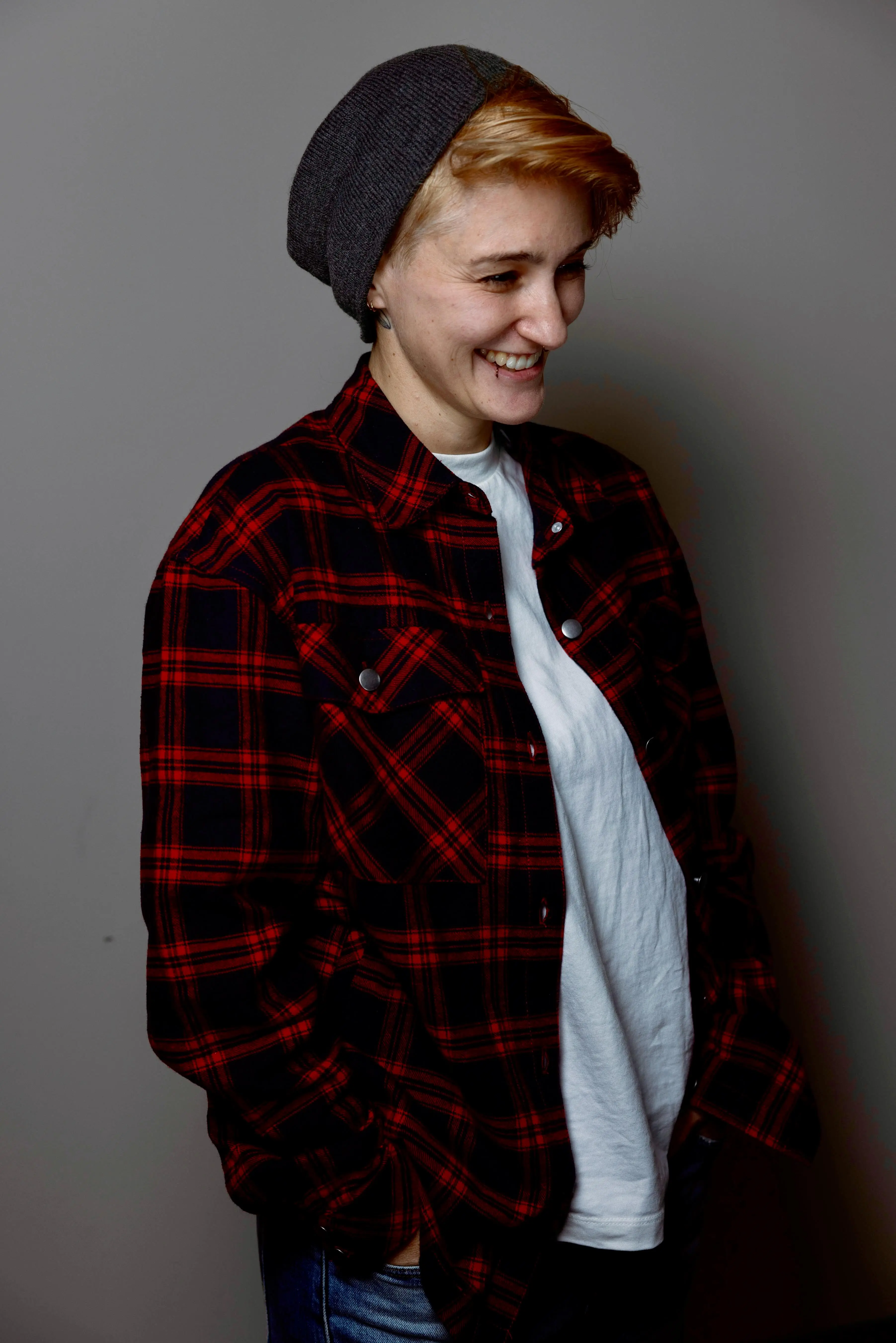 Portrait photo of a smiling person, shot from the side, face visible in profile